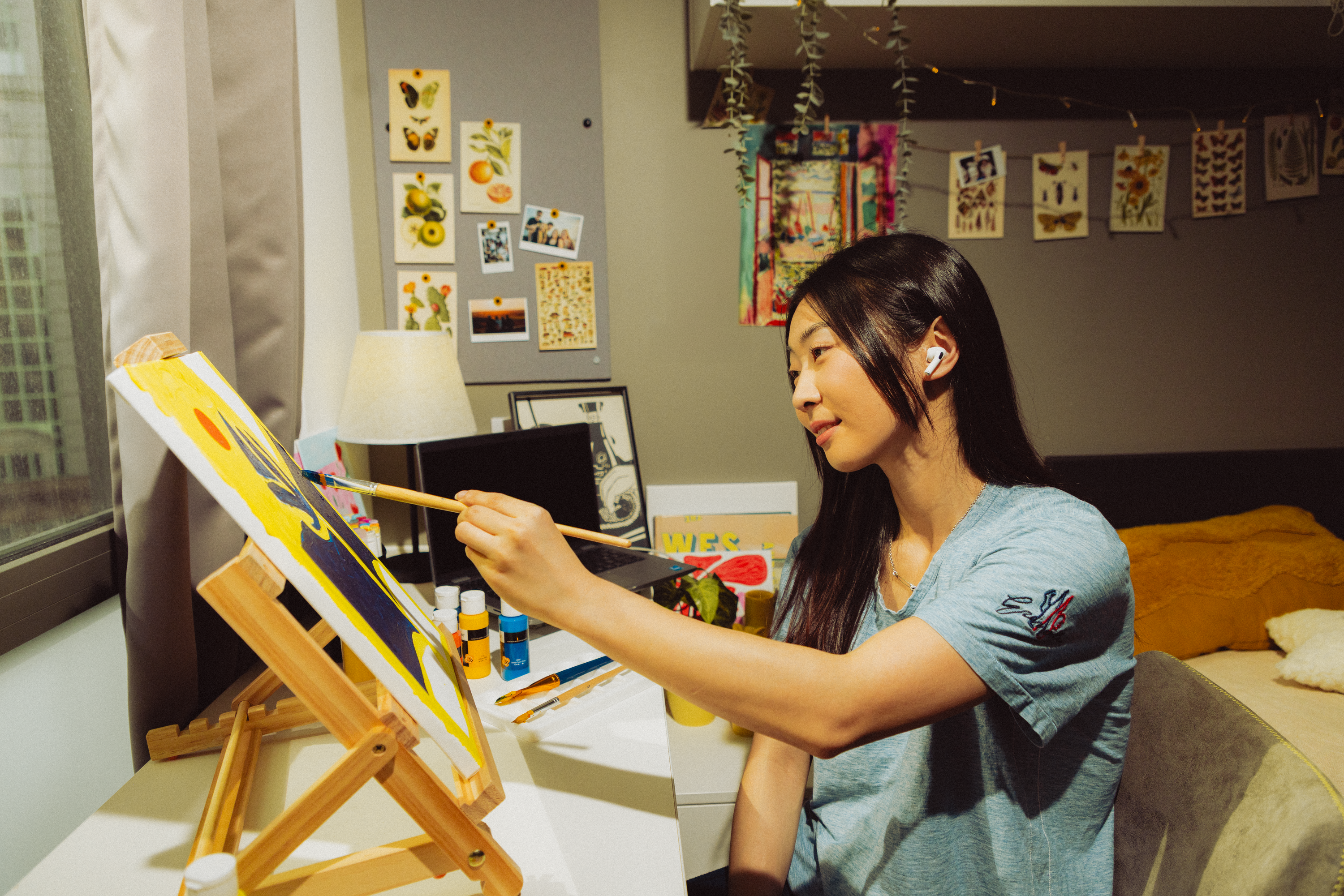 Student painting in a room