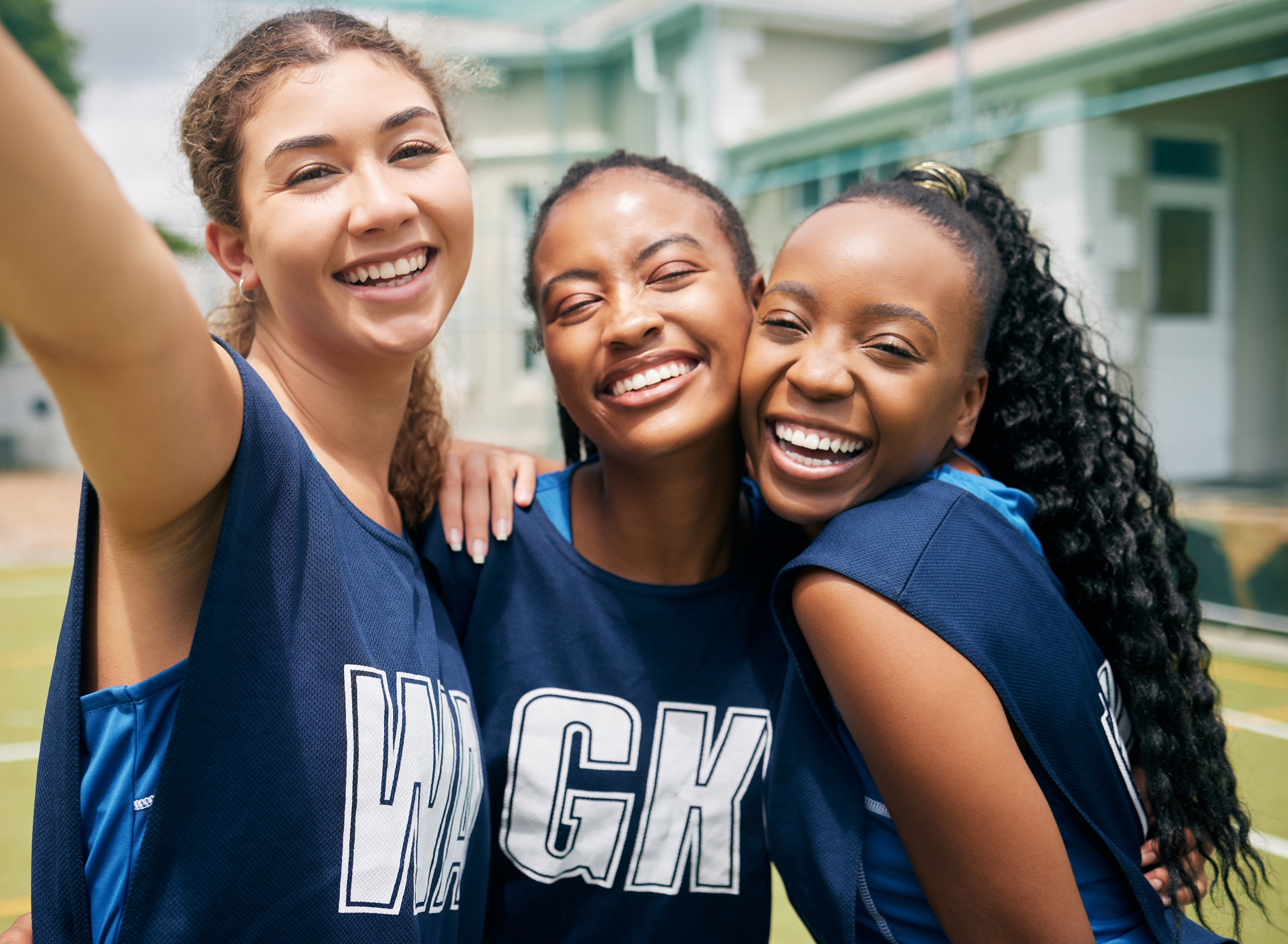 Three girls wearing sports kit