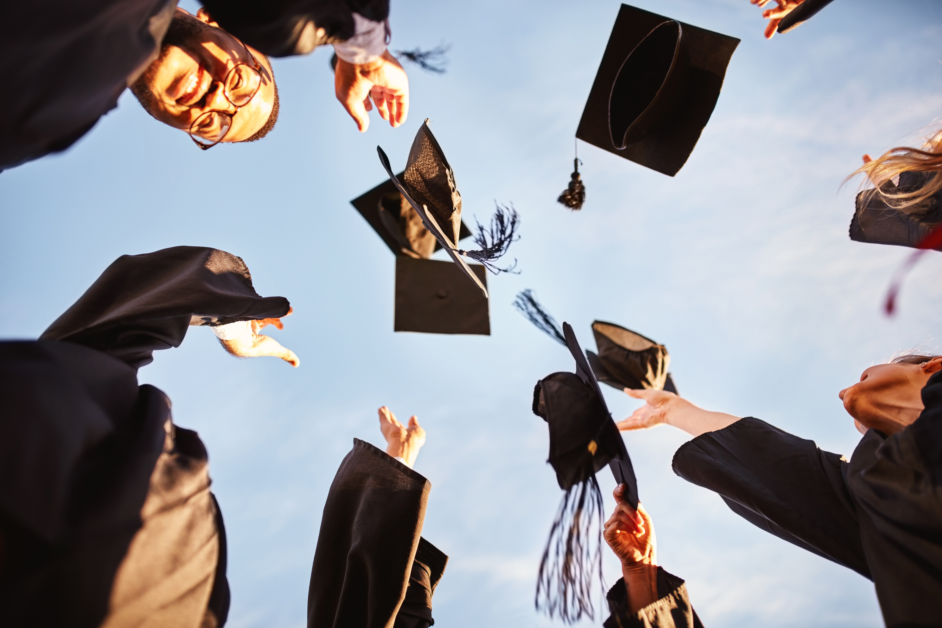 Photo of students throwing hats in air