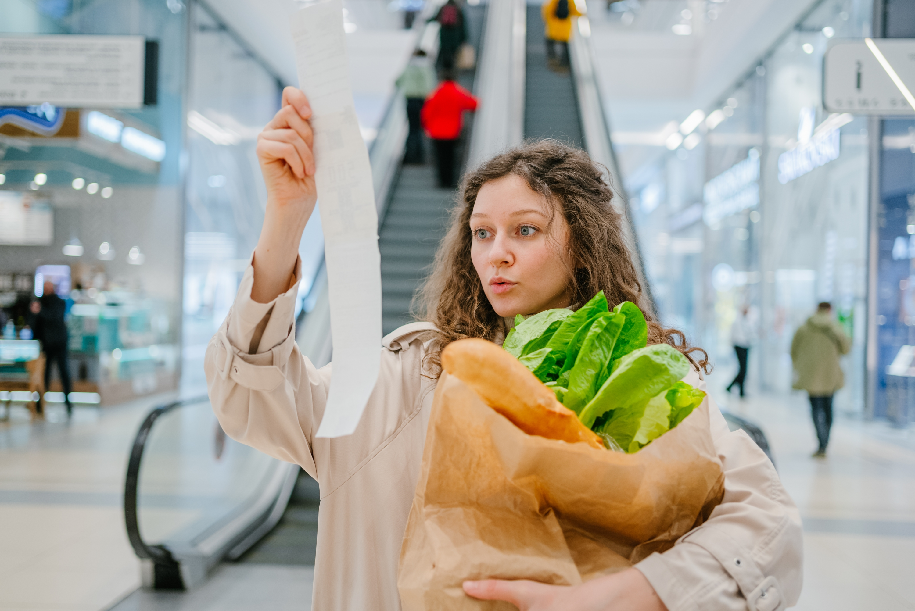 Girl holding receipt and groceries