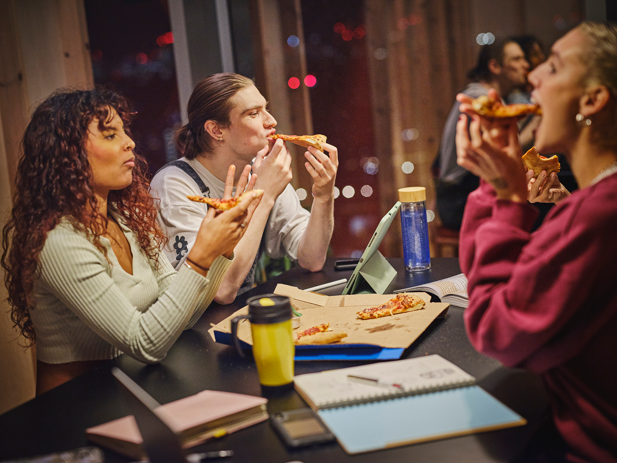Students eating pizza whilst studying