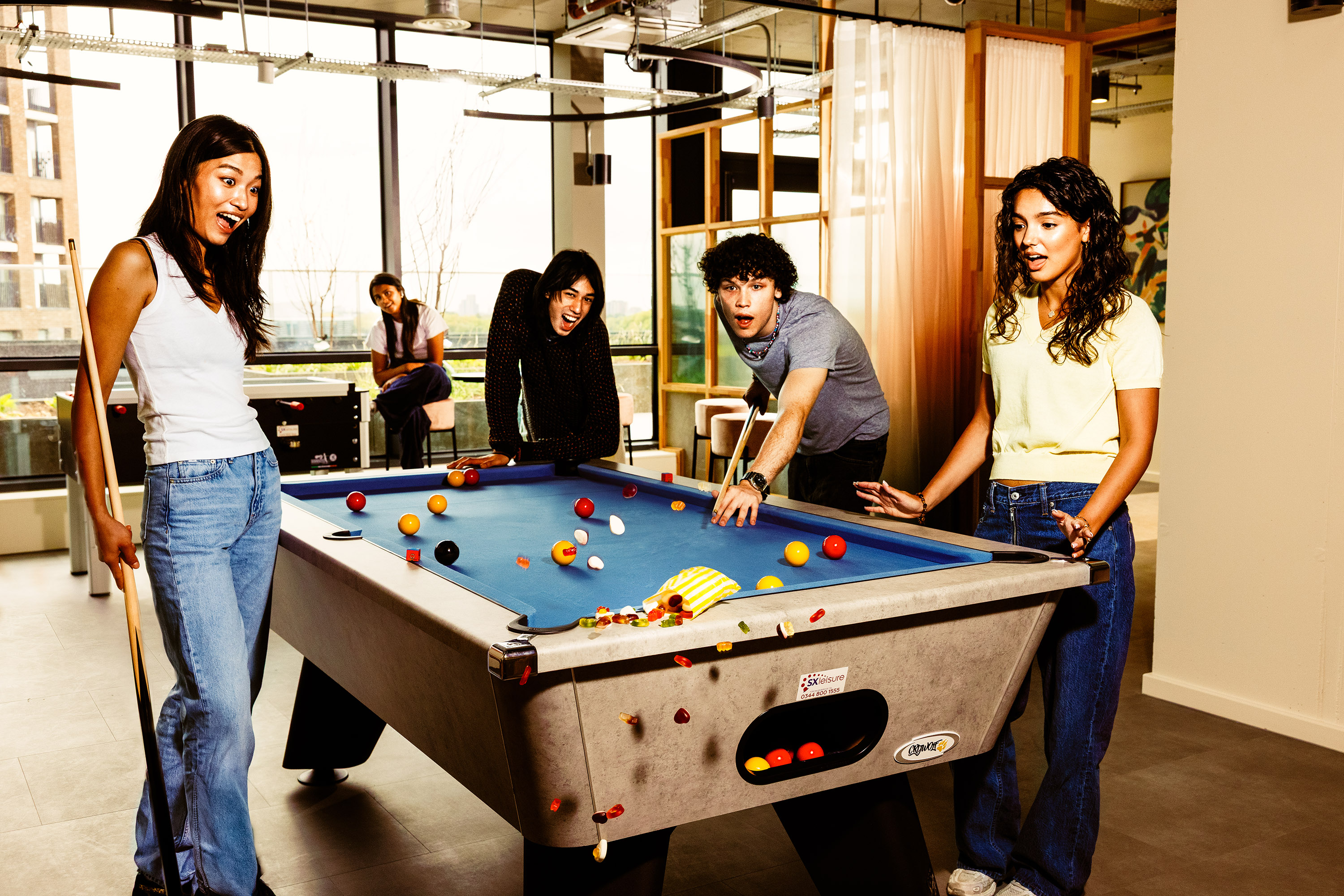 Students in the Common Room playing pool